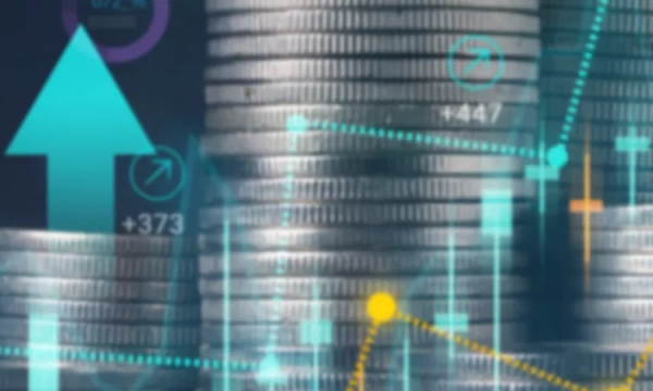 A close-up of stacked coins with upward arrows and financial graphs, symbolizing economic growth and investment trends.