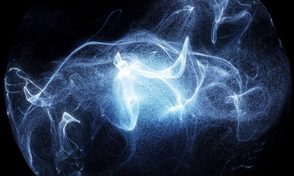 Abstract blue and white wispy smoke or light patterns swirling against a black background, creating an ethereal and fluid visual effect.