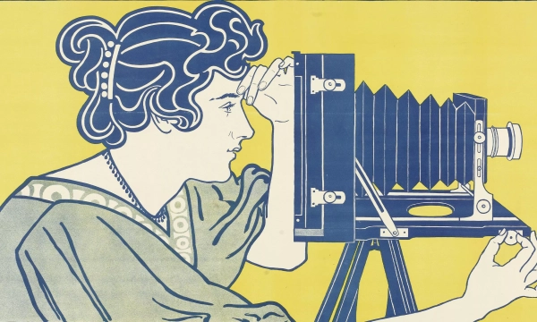 A woman with styled hair adjusts a vintage camera on a tripod, depicted in a blue silhouette against a bright yellow background.