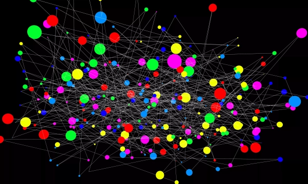 A colorful, complex network of interconnected nodes and links, featuring various sizes of dots in red, blue, green, yellow, pink, and purple against a black background.