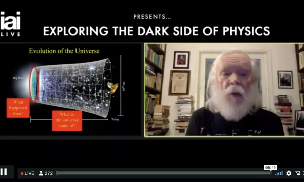 A man with a long white beard discusses the evolution of the universe, referencing concepts like the Big Bang and dark matter in a virtual presentation.