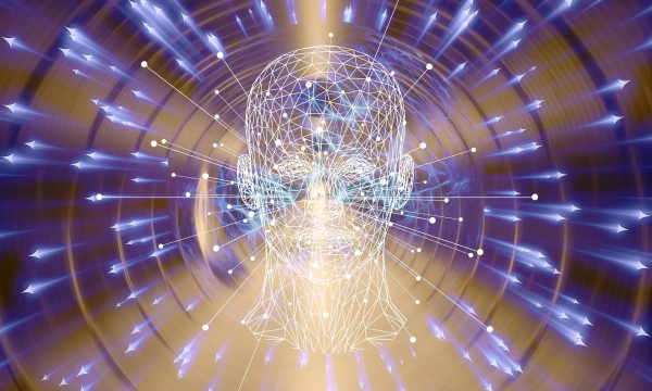 A glowing, geometric representation of a human head surrounded by swirling lines and dots suggesting energy and thought processes.